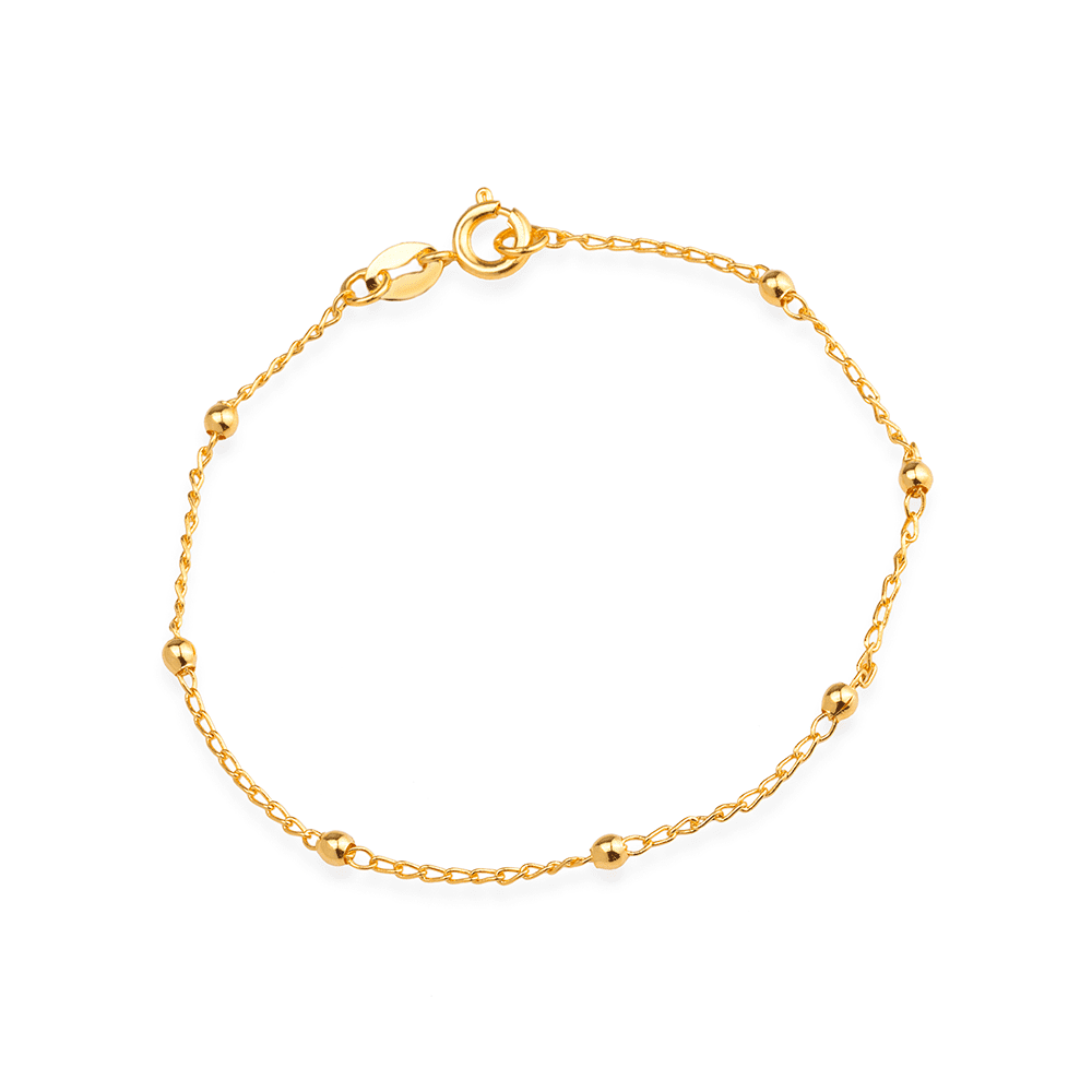 Pulseira delicada com acabamento dourado aparente, fotografada sobre fundo claro