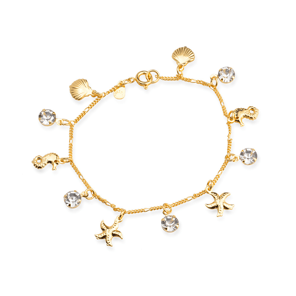 Pulseira dourada com pingentes de concha, estrela-do-mar e pontos de luz, sobre fundo claro